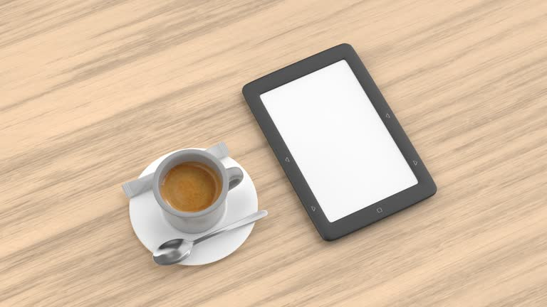 A coffee cup and an e-reader rest on a wooden table, symbolizing the convenience of e-ink technology.